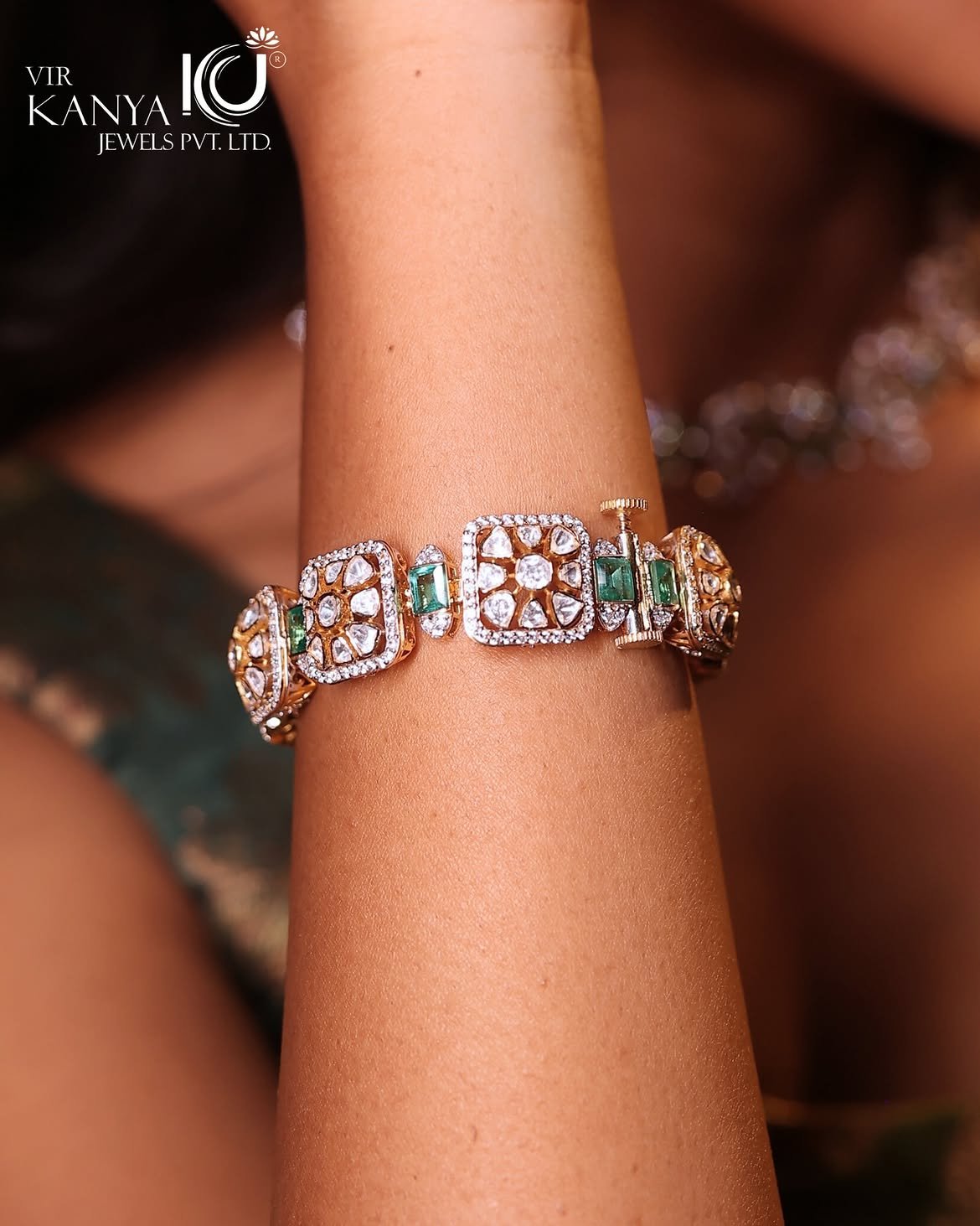 A fine gold chain bracelet worn at the wrist