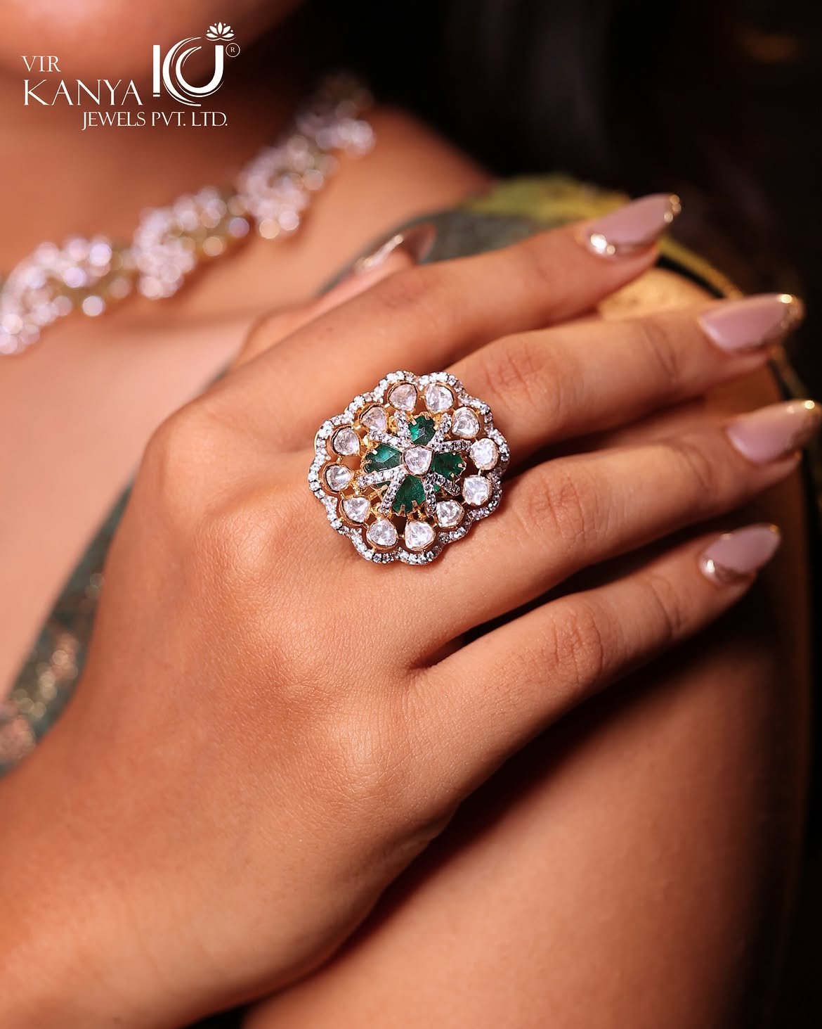 A statement gold ring worn on a model's hand